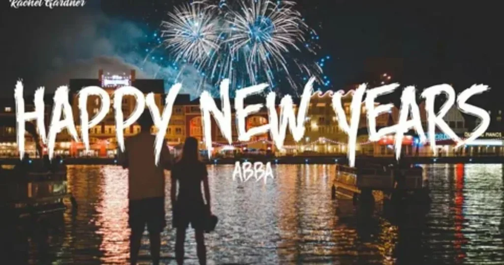 Couple watching Happy New Year fireworks display over illuminated waterfront at night