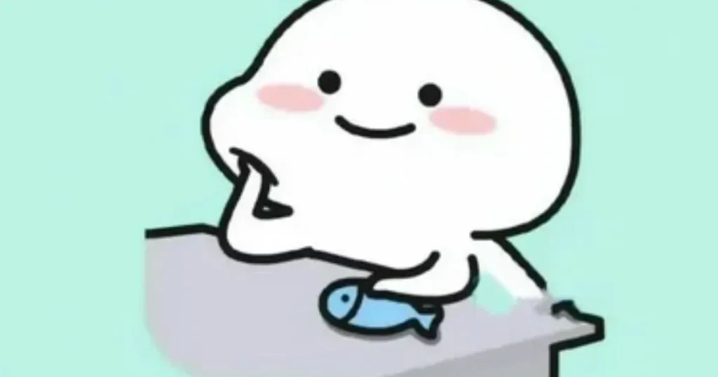 Cute white blob cartoon character with blushing cheeks sitting on table